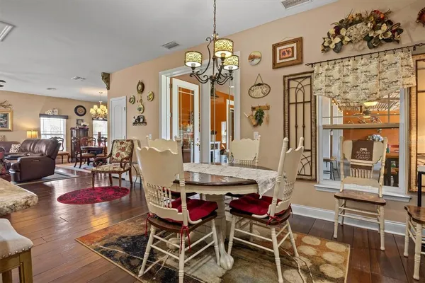 a living room with lots of furniture and kitchen view