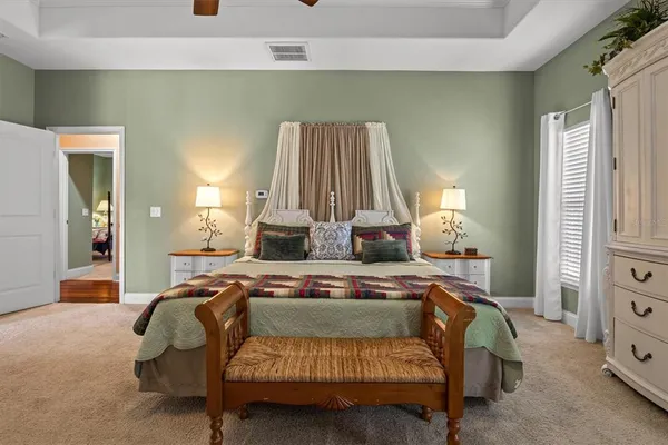 a bedroom with a bed and a chandelier