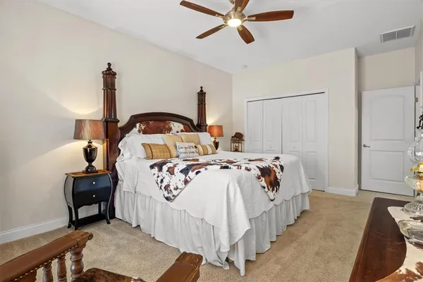 a bedroom with bed and a chandelier