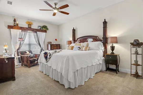 a dining room with furniture large windows and a chandelier