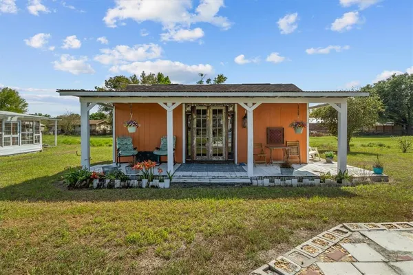a front view of a house with basket ball court and outdoor seating