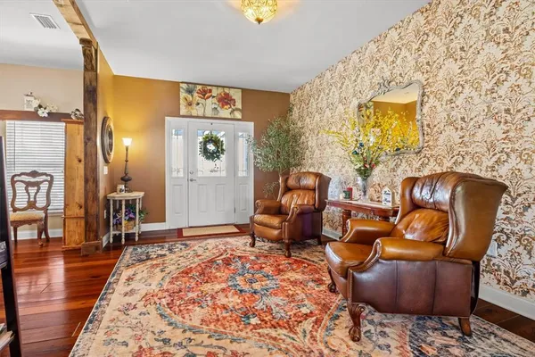 a living room with furniture and wooden floor