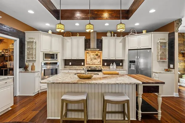 a kitchen with lots of counter top space and stainless steel appliances