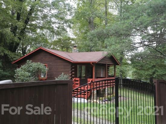 155 Rustic Heights Road Waynesville, NC 28785 - Photo 1 of 1 a front view of a house with a garden