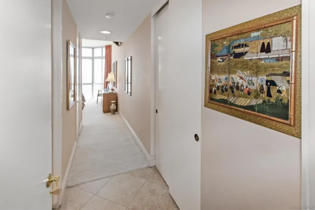 a view of a hallway with wooden floor and doors