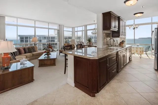a large kitchen with a large counter top and outdoor space