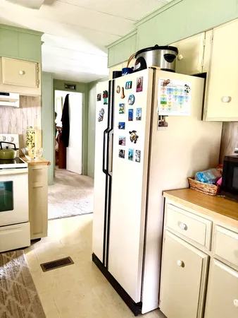 a kitchen with a refrigerator and a stove