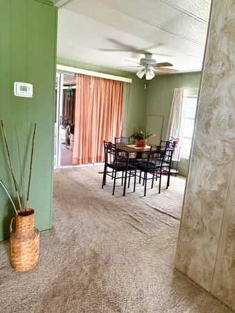 a dining room with furniture and window