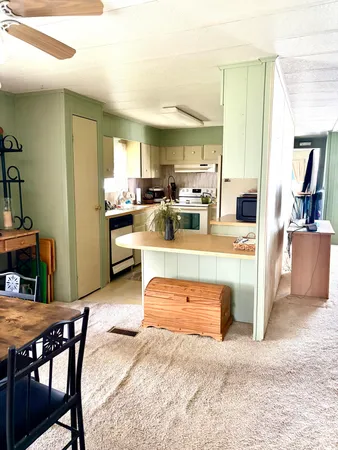 a view of kitchen with kitchen island dining table and chairs