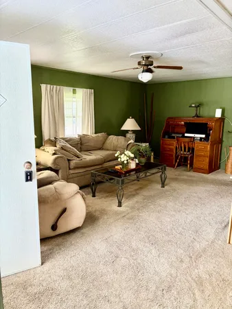 a living room with furniture and chandelier