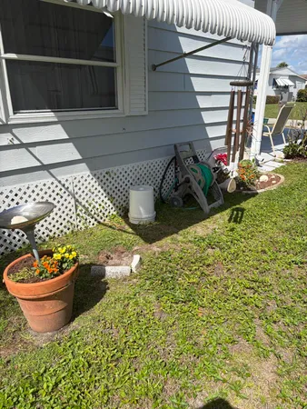 a view of a backyard with plants and entertaining space