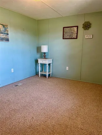 an empty room and a bathroom with a bathroom