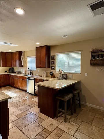 a kitchen with a sink a counter top space and appliances