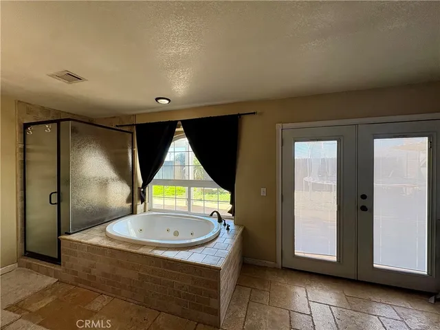 a bathroom with a bathtub sink and mirror