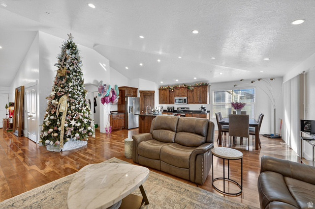 141 Wolverine Creek Elk Ridge, UT 84651 - Photo 8 of 47 Living room with light wood-style floors, vaulted ceiling, and recessed lighting