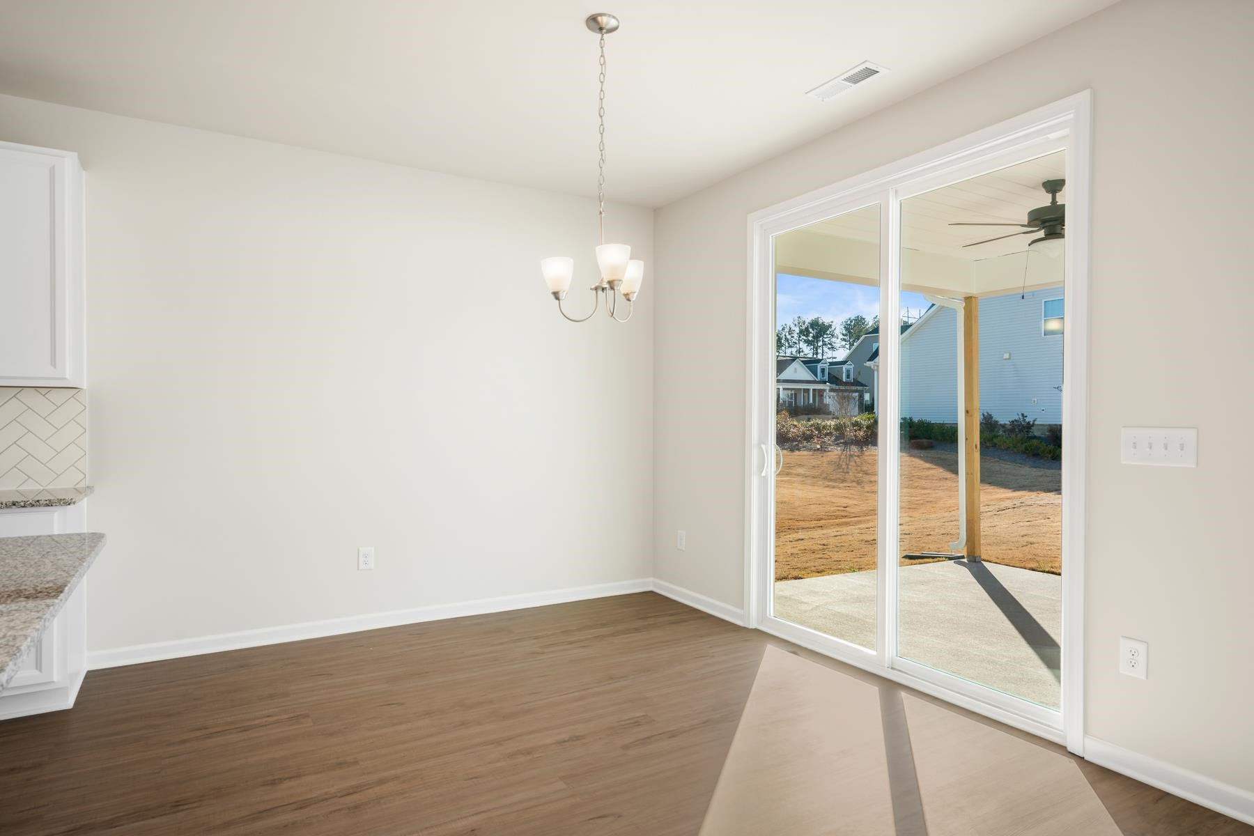 158 Karlov Road Garner, NC 27529 - Photo 15 of 37 an empty room with wooden floor and windows