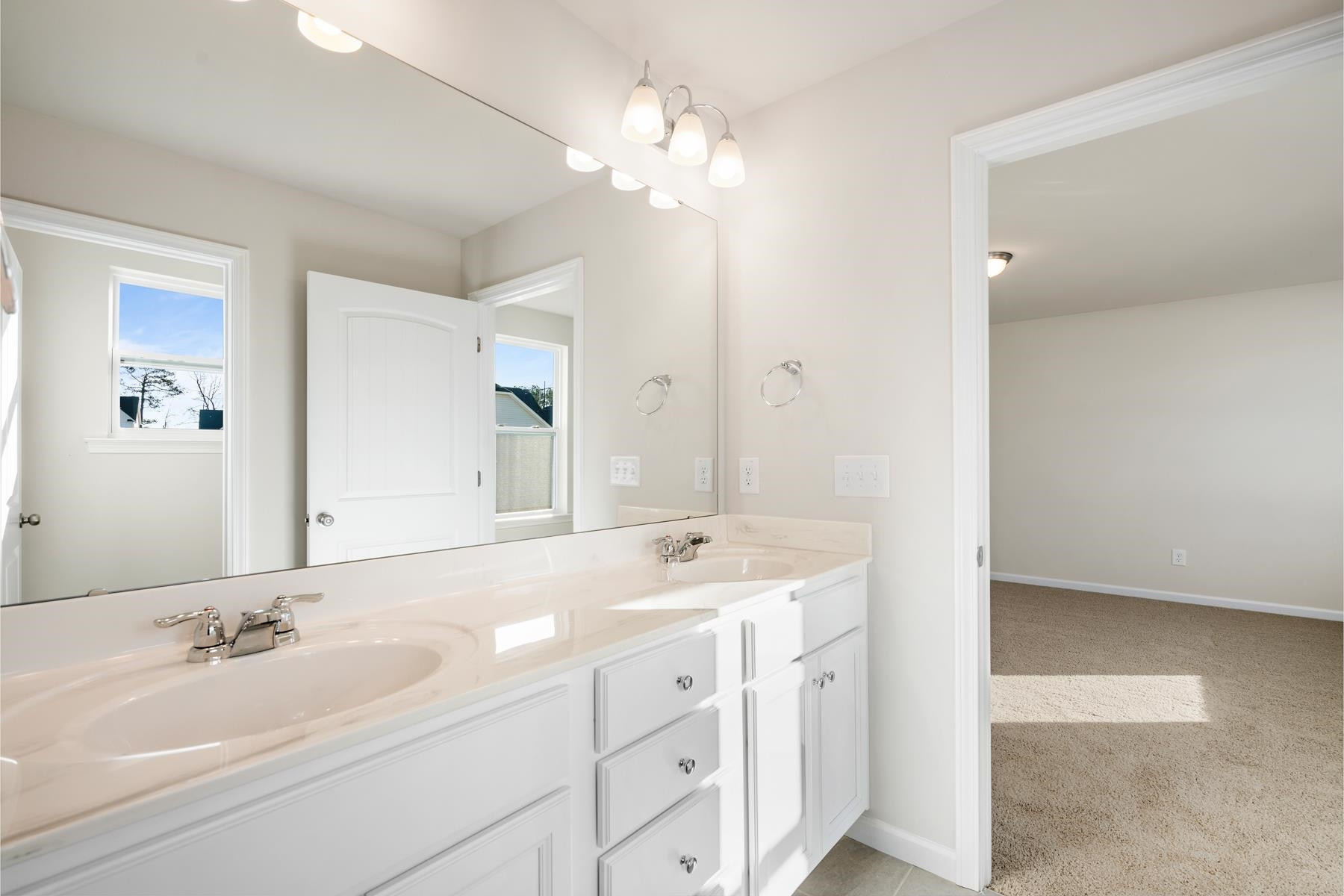 158 Karlov Road Garner, NC 27529 - Photo 22 of 37 a bathroom with a sink double vanity and a mirror