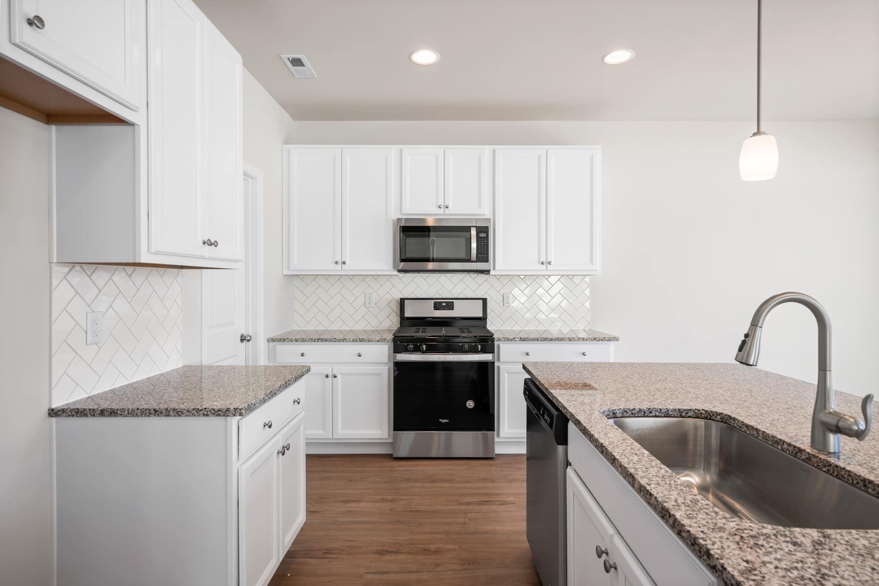 158 Karlov Road Garner, NC 27529 - Photo 3 of 37 a kitchen with granite countertop a sink stainless steel appliances and cabinets
