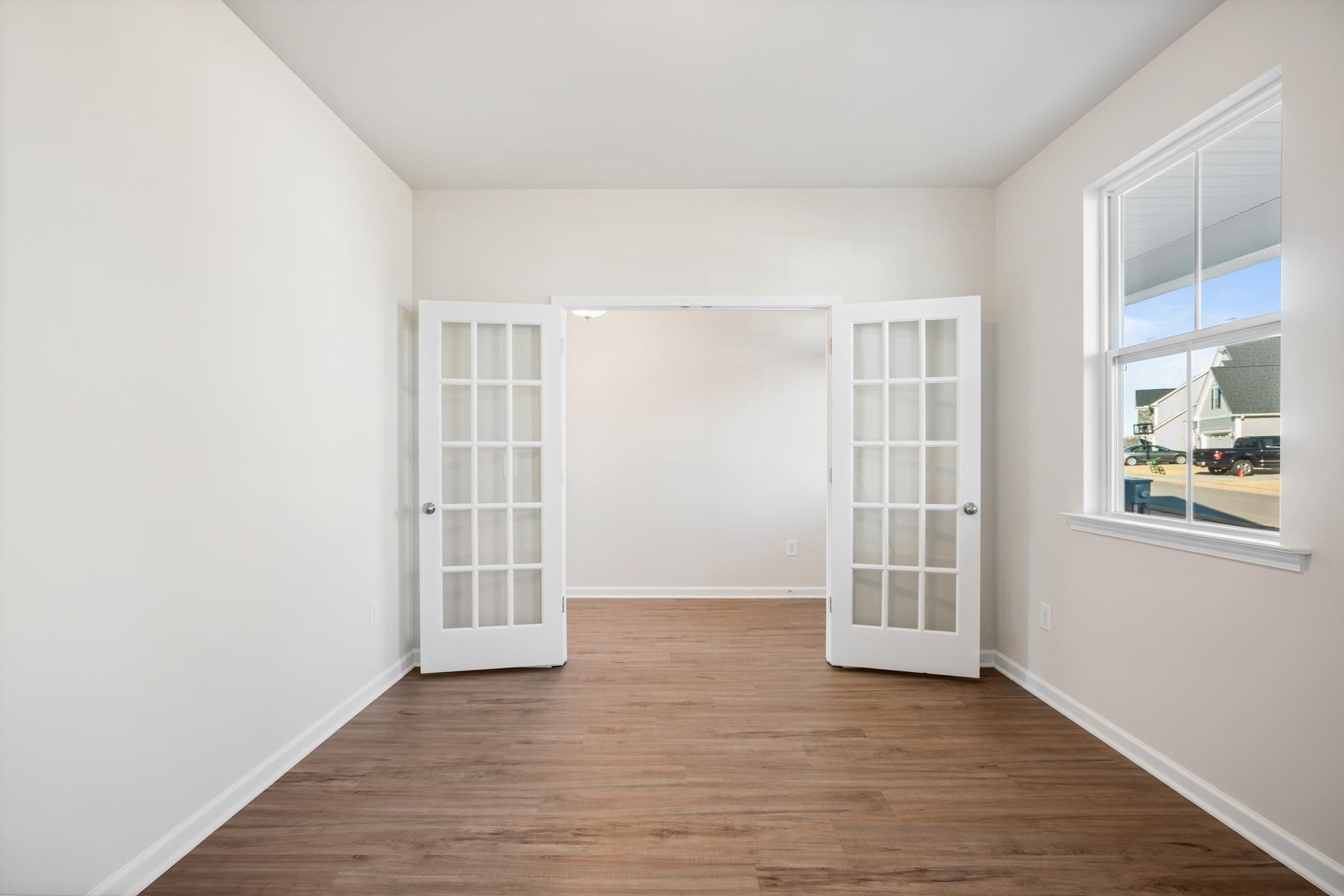 158 Karlov Road Garner, NC 27529 - Photo 5 of 37 an empty room with wooden floor and windows