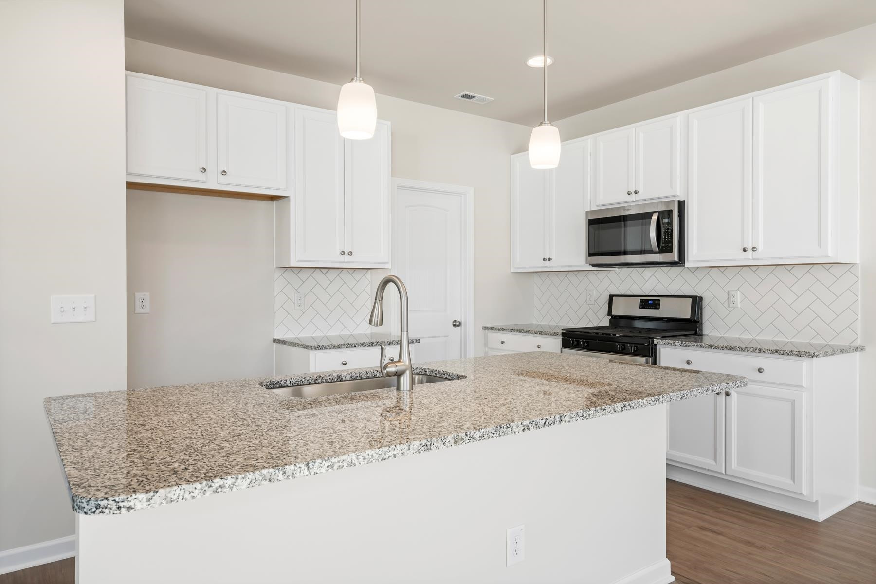 158 Karlov Road Garner, NC 27529 - Photo 10 of 37 a kitchen with granite countertop a sink a counter top space appliances and cabinets