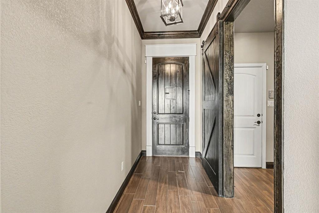 104 Stanford Lane Springtown, TX 76082 - Photo 3 of 28 a view of a hallway with wooden floor and staircase