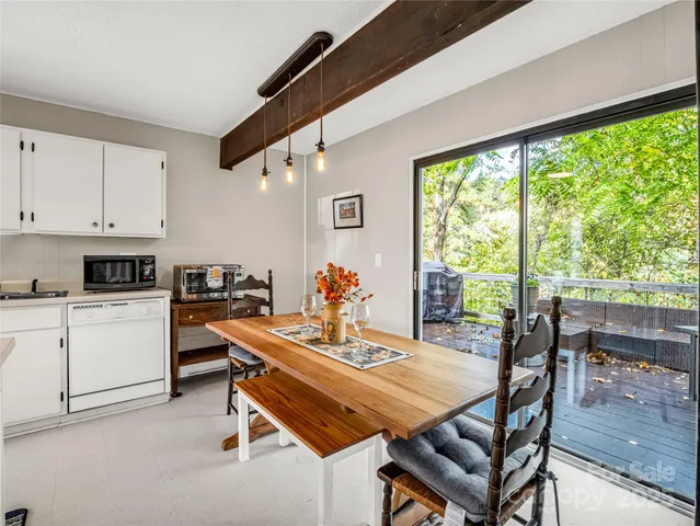 a dining room with furniture and a floor to ceiling window