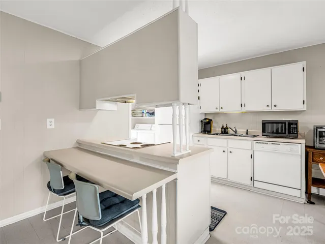 a kitchen with stainless steel appliances cabinets and white table top