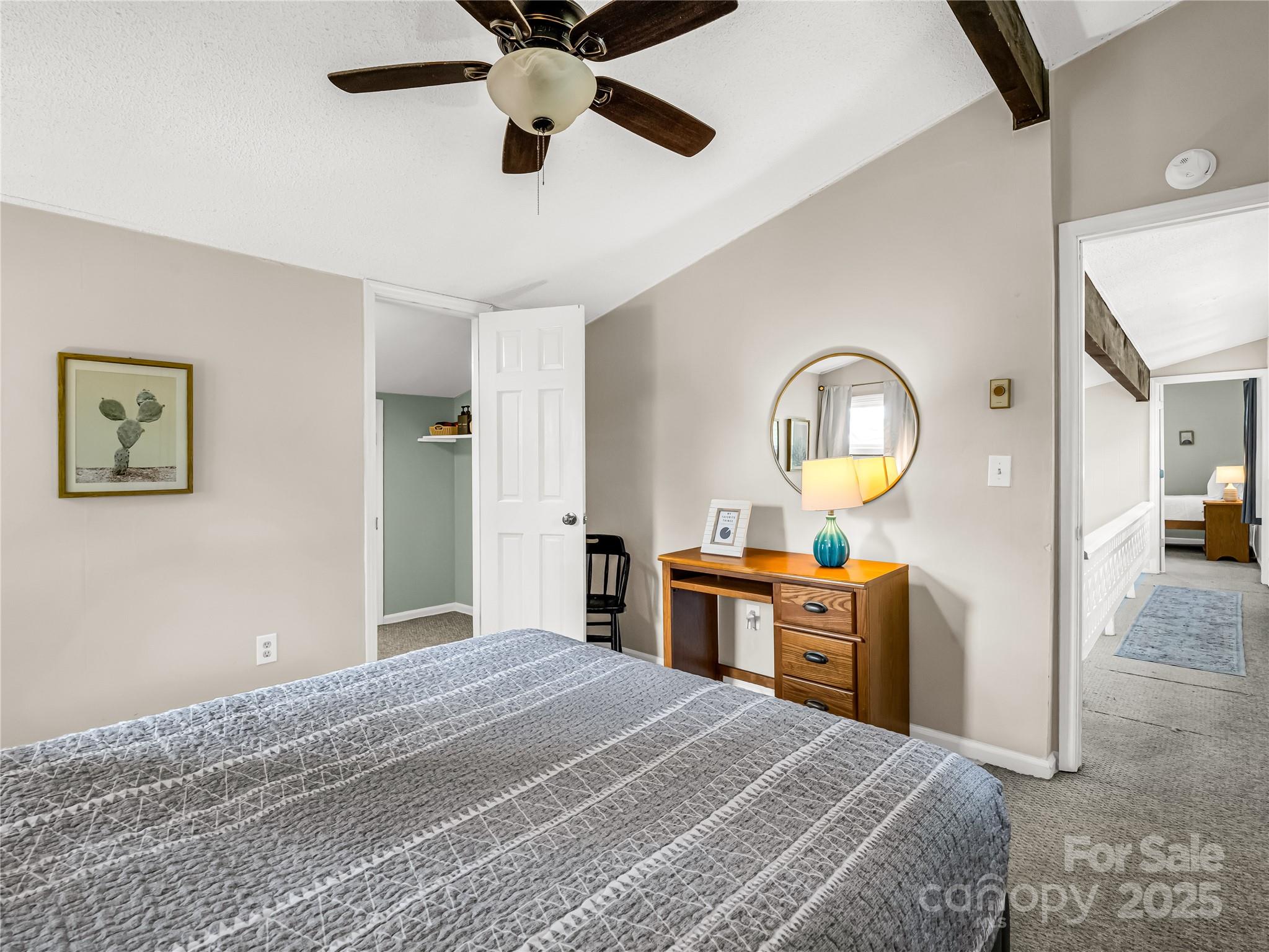 486 Oxford Road Lake Junaluska, NC 28745 - Photo 22 of 35 a bedroom with a bed and a chandelier