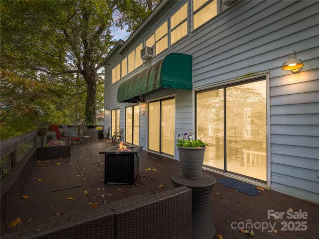a living room with patio furniture and a floor to ceiling window