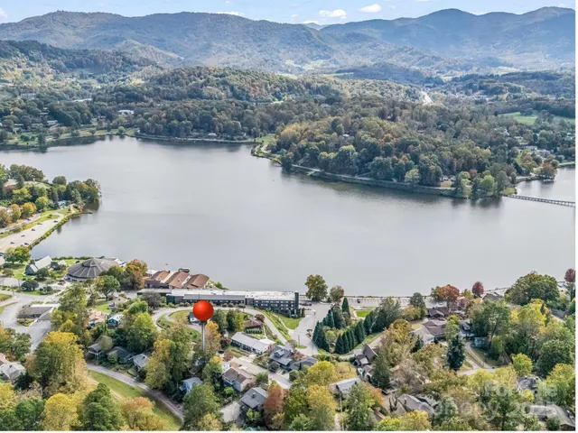 an aerial view of a house and a mountain view