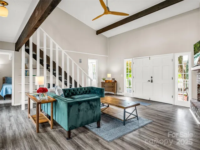 a living room with furniture and wooden floor