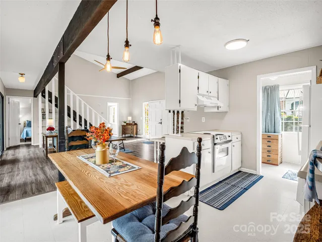 a living room with dining table furniture and a chandelier