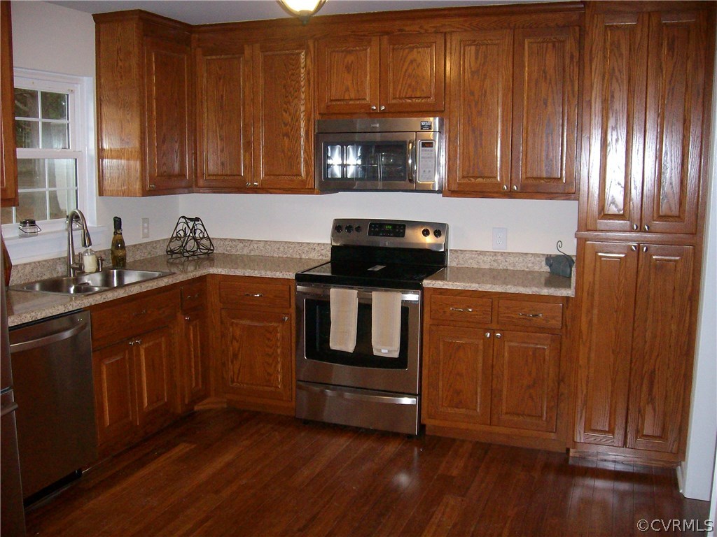 5425 West Hundred Road Chester, VA 23831 - Photo 9 of 14 a kitchen with granite countertop wooden cabinets and a stove top oven