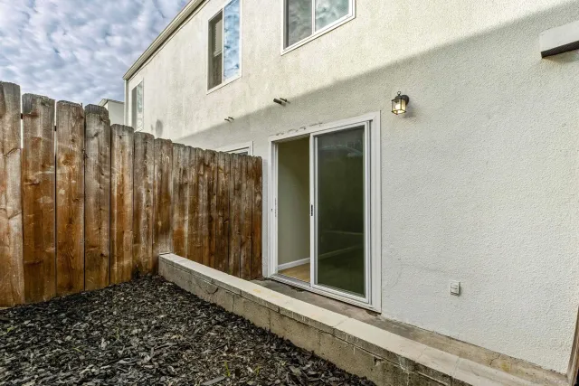 a view of a house with a wooden fence
