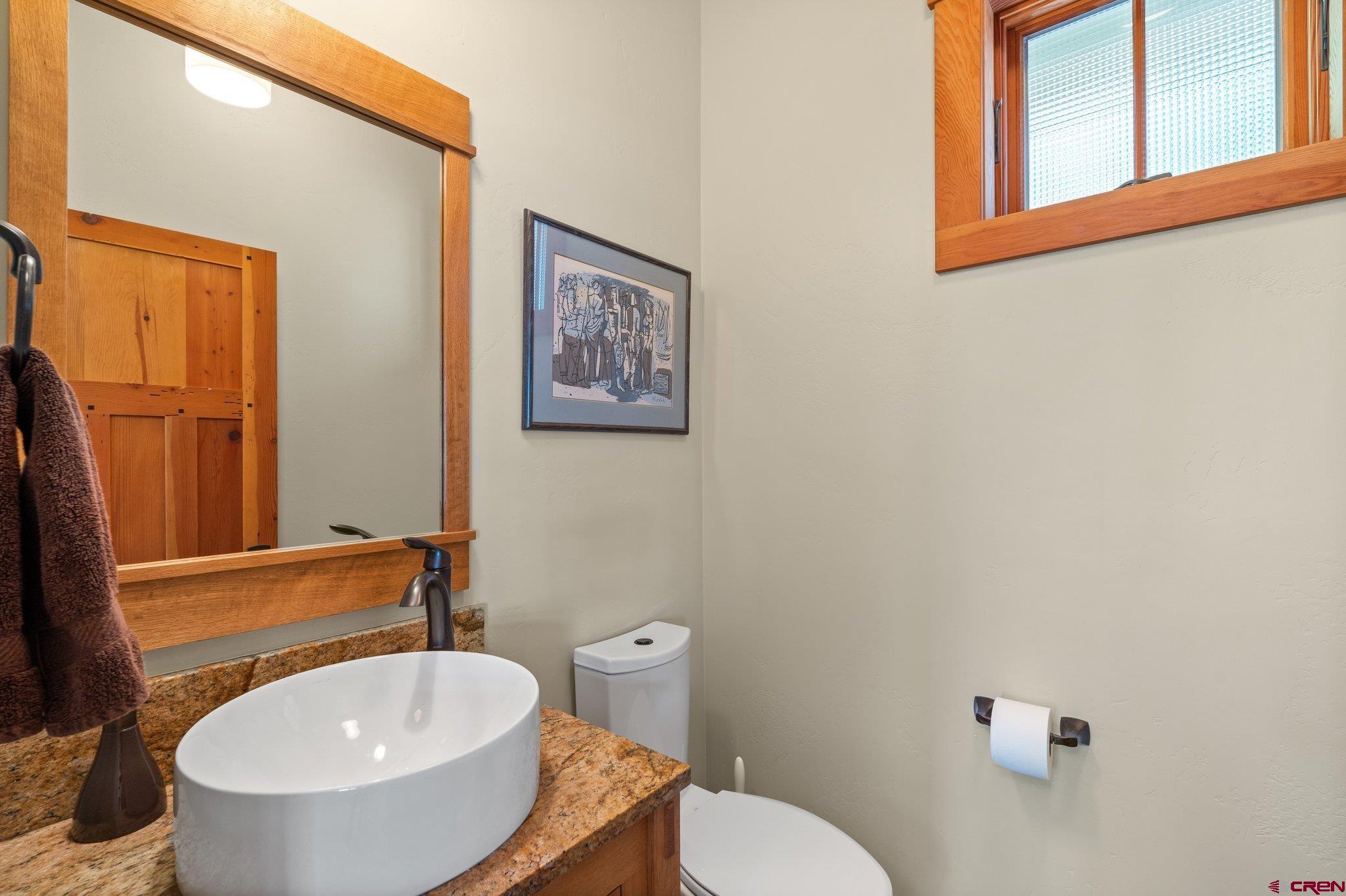 1393 East 3rd Avenue Durango, CO 81301 - Photo 16 of 35 a bathroom with a toilet a sink and mirror