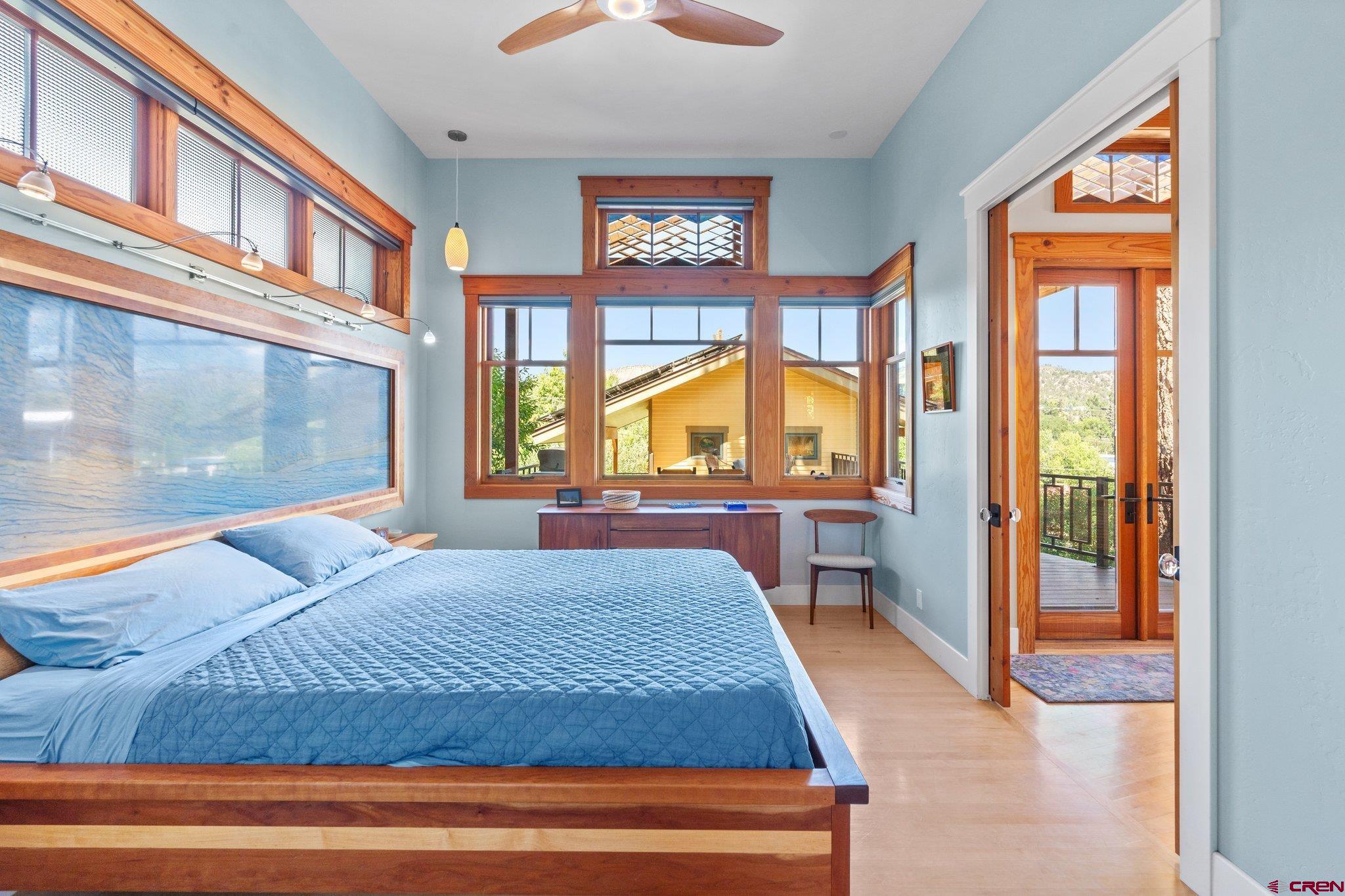 1393 East 3rd Avenue Durango, CO 81301 - Photo 18 of 35 a bedroom with a large bed and a large window