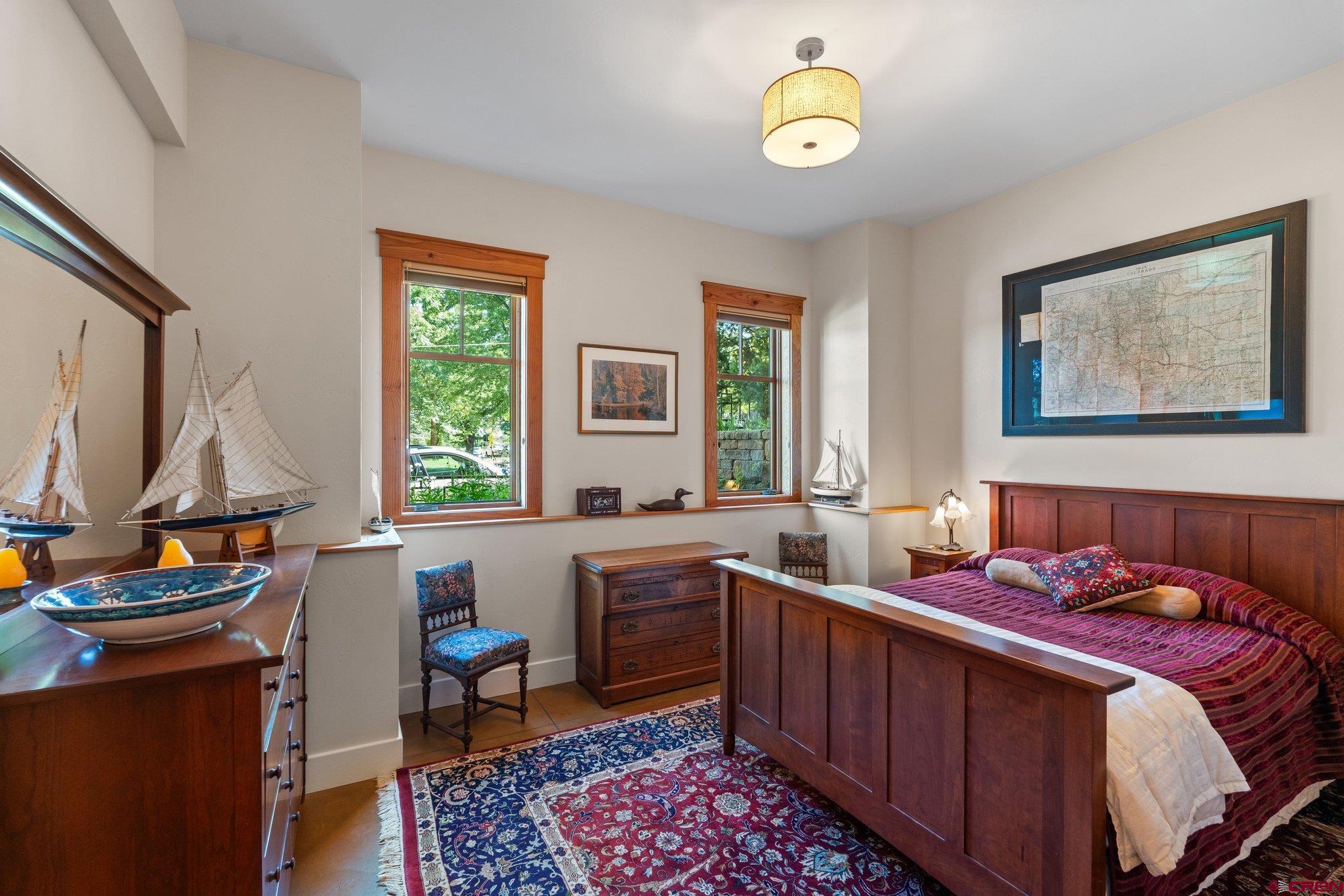 1393 East 3rd Avenue Durango, CO 81301 - Photo 22 of 35 a bedroom with a bed and a chandelier