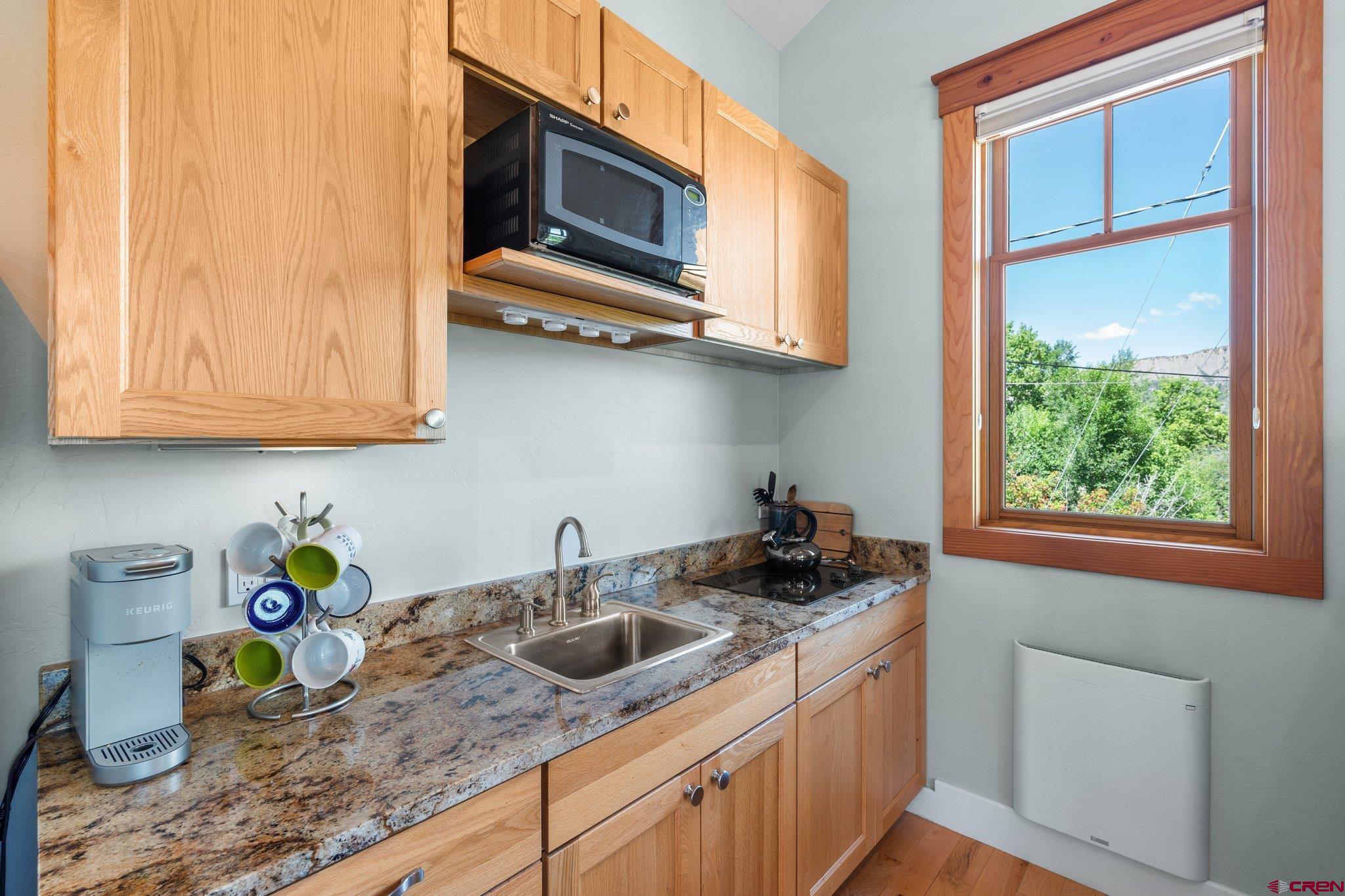 1393 East 3rd Avenue Durango, CO 81301 - Photo 31 of 35 a kitchen with stainless steel appliances granite countertop a sink a stove and microwave