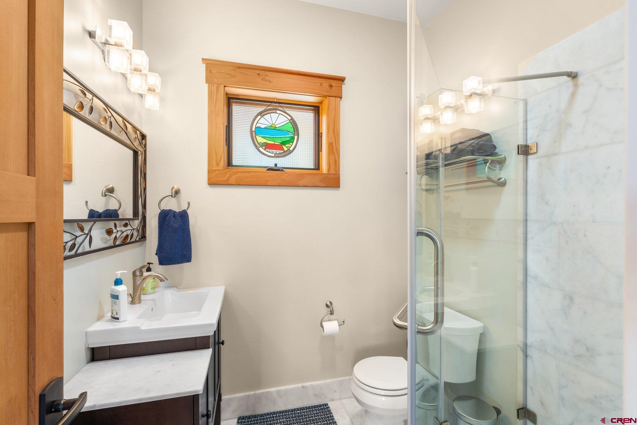 1393 East 3rd Avenue Durango, CO 81301 - Photo 33 of 35 a bathroom with a toilet a sink and a mirror