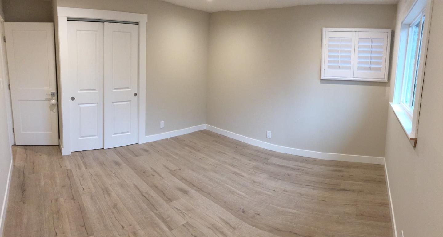 838 Tulane Drive Mountain View, CA 94040 - Photo 13 of 20 an empty room with wooden floor and windows