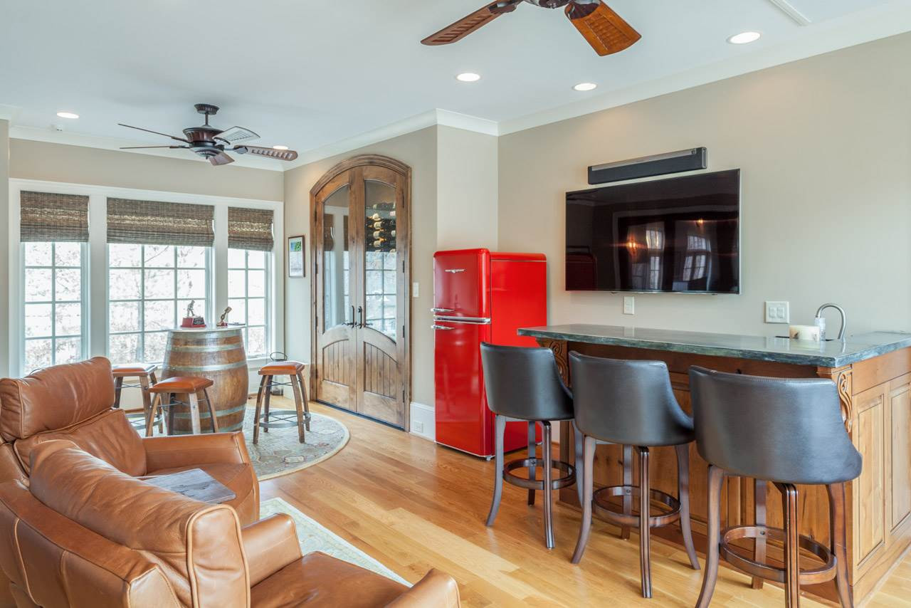 3032 Cone Manor Lane Raleigh, NC 27613 - Photo 28 of 30 The wine room and bar adjoins the luxury garage suite through a wall of expandable folding doors. Features include a bar w/zinc counter tops, hardwood floors, wine storage cabinet, and full bath. This convenient space is easily accessible from the pool. Wine Room and Entertainment Bar
