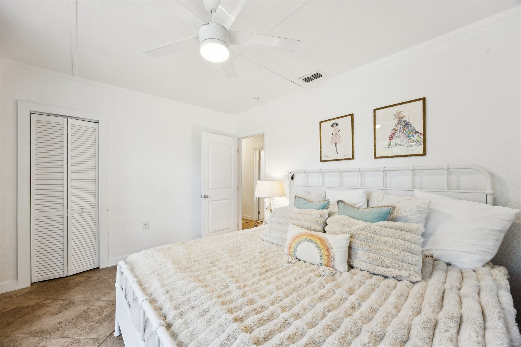 411 South 5th Street Fernandina Beach, FL 32034 - Photo 18 of 43 a bedroom with a large bed and a chandelier