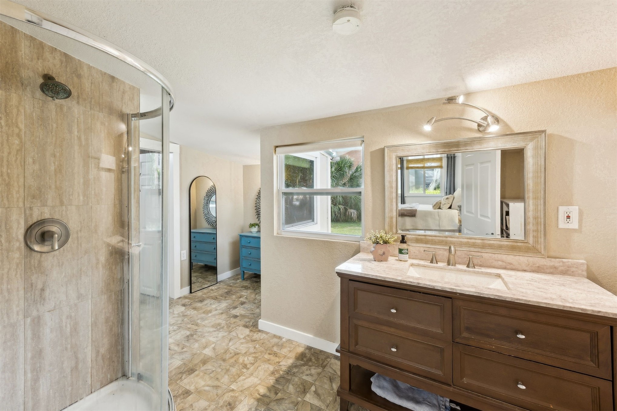 411 South 5th Street Fernandina Beach, FL 32034 - Photo 22 of 43 a bathroom with a double vanity sink mirror and shower