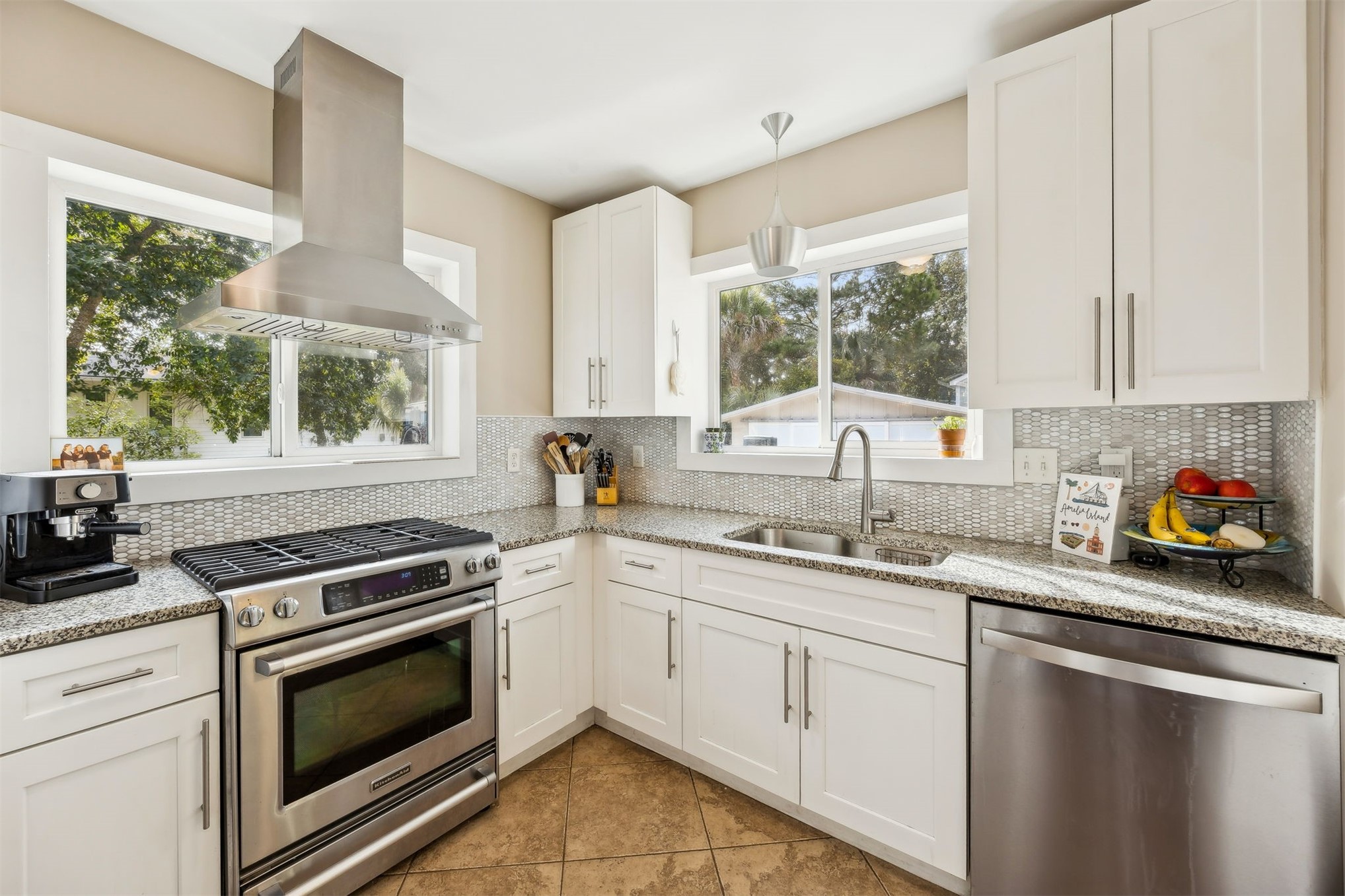 411 South 5th Street Fernandina Beach, FL 32034 - Photo 10 of 43 a kitchen with a stove a sink and a window