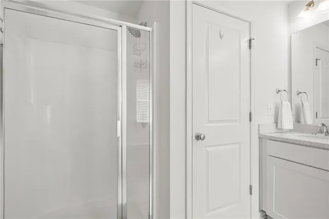 a bathroom with a shower and a sink