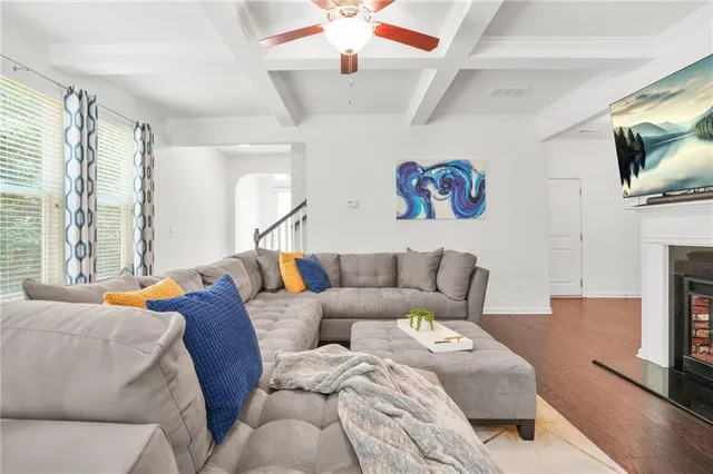 a living room with fireplace furniture and a flat screen tv