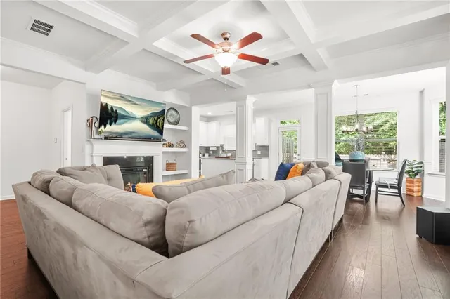 a living room with furniture fireplace and a large window