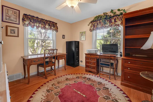 a view of a livingroom with furniture window and wooden floor