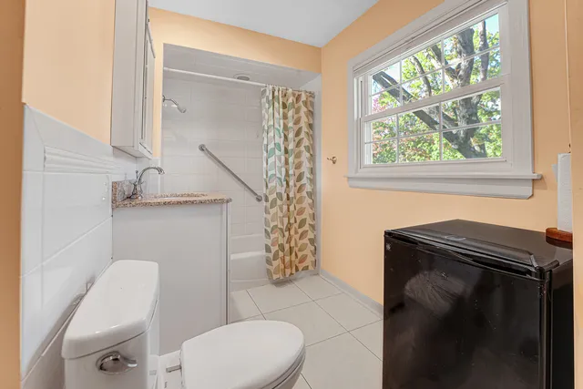 a bathroom with a toilet a sink and tub