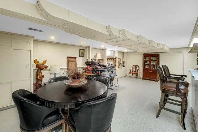 a dining room with furniture and a kitchen view